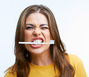 Girl Biting Toothbrush