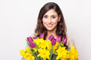 Woman smiling over flowers